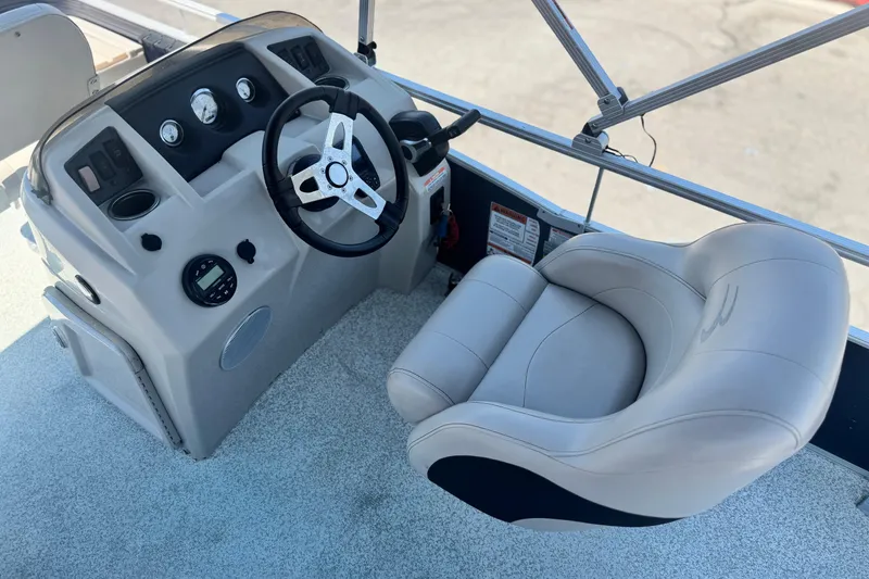 Slide: The Image of 2019 Bennington 188 SV boat helm with steering wheel and comfortable captain's chair. - 22