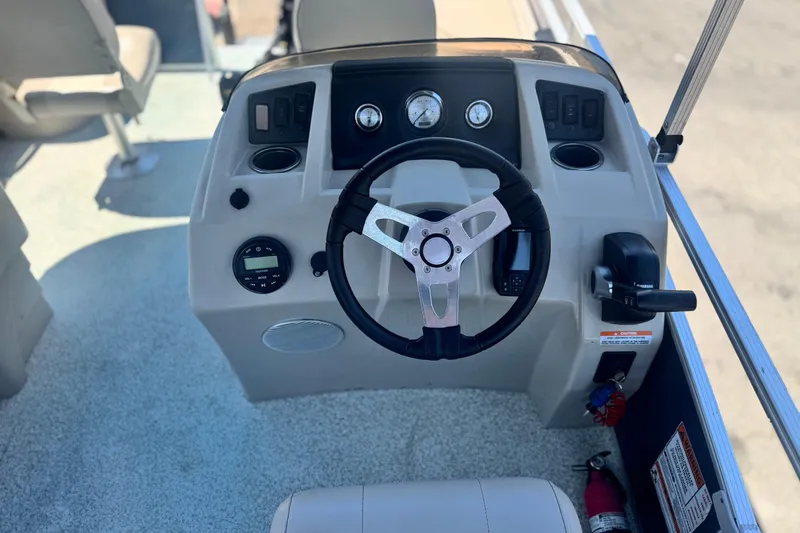 Slide: The Image of 2019 Bennington 188 SV boat dashboard with steering wheel and controls. - 23