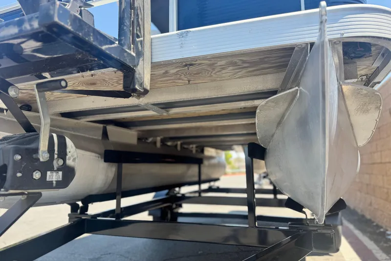Slide: The Image of 2019 Bennington 188 SV pontoon boat on trailer, showing undercarriage and pontoons. - 4