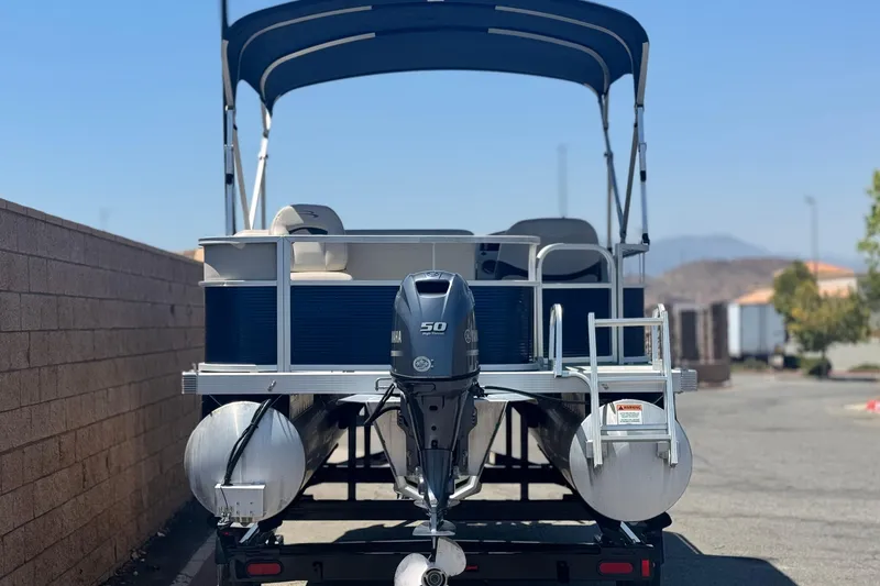 Slide: The Image of 2019 Bennington 188 SV pontoon boat with Yamaha 50 engine, parked outdoors. - 5
