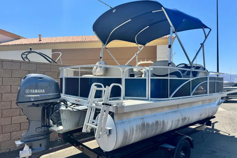 Slide: The Image of 2019 Bennington 188 SV pontoon boat with Yamaha motor and blue canopy. - 6