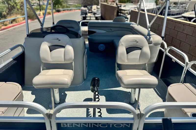 Slide: The Image of 2019 Bennington 188 SV pontoon boat interior with seating and steering console. - 9