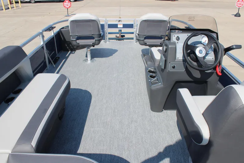Slide: The Image of 2026 Sun Tracker Bass Buggy 18 DLX pontoon boat interior with seating and steering console. - 14
