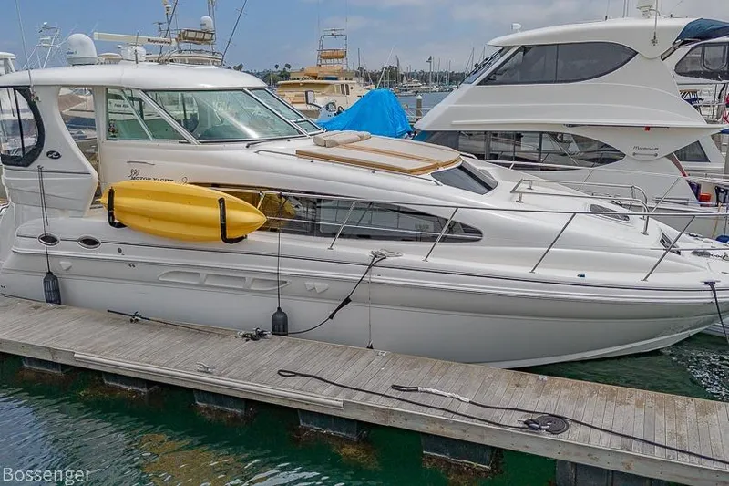 The Image of 2005 Sea Ray 390 Motor Yacht docked with a yellow kayak on the side. - 0