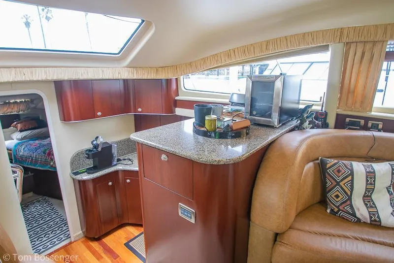 Slide: The Image of Interior of 2005 Sea Ray 390 Motor Yacht with modern kitchen and cozy seating area. - 16