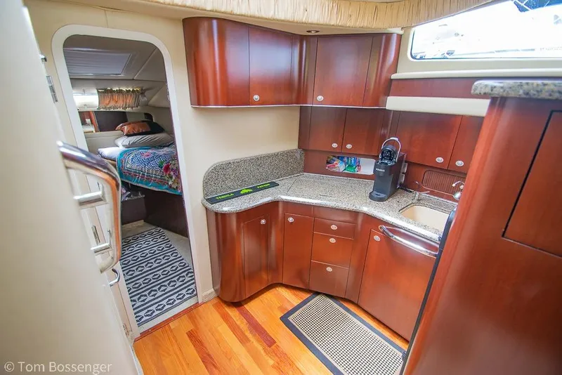 Slide: The Image of Luxurious 2005 Sea Ray 390 Motor Yacht interior with modern kitchen and cozy bedroom. - 18