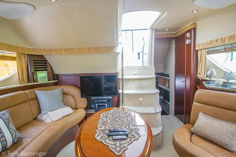 Slide: The Image of Luxurious interior of 2005 Sea Ray 390 Motor Yacht with plush seating and entertainment center. - 22