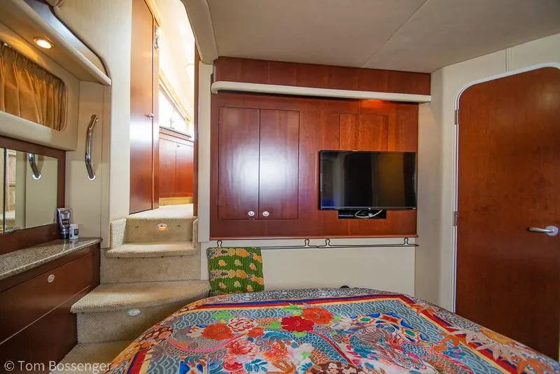 Slide: The Image of Luxurious 2005 Sea Ray 390 Motor Yacht interior with TV and vibrant bedding. - 26