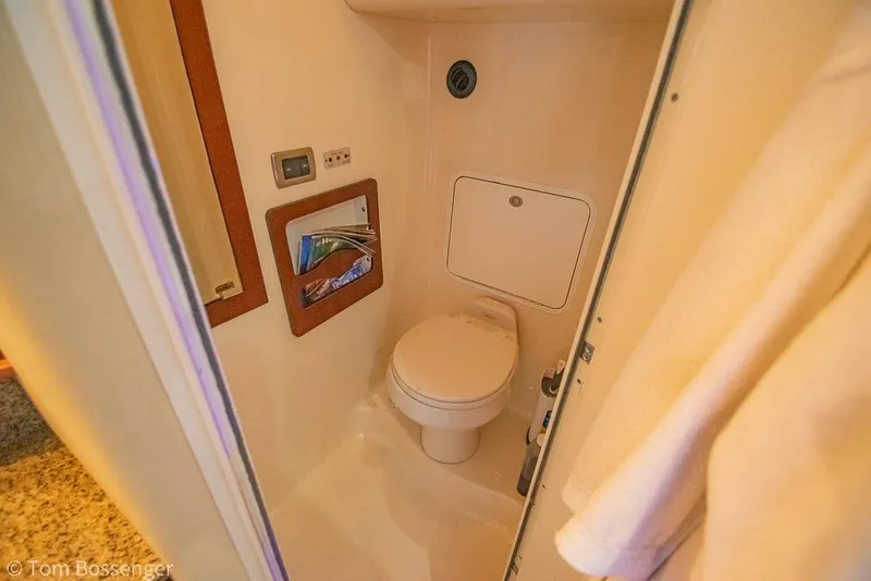 Slide: The Image of 2005 Sea Ray 390 Motor Yacht bathroom with toilet and storage compartment. - 29