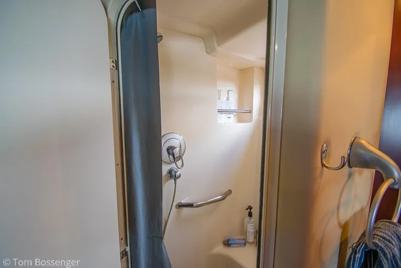 Slide: The Image of Shower area inside 2005 Sea Ray 390 Motor Yacht, featuring modern fixtures and storage. - 30