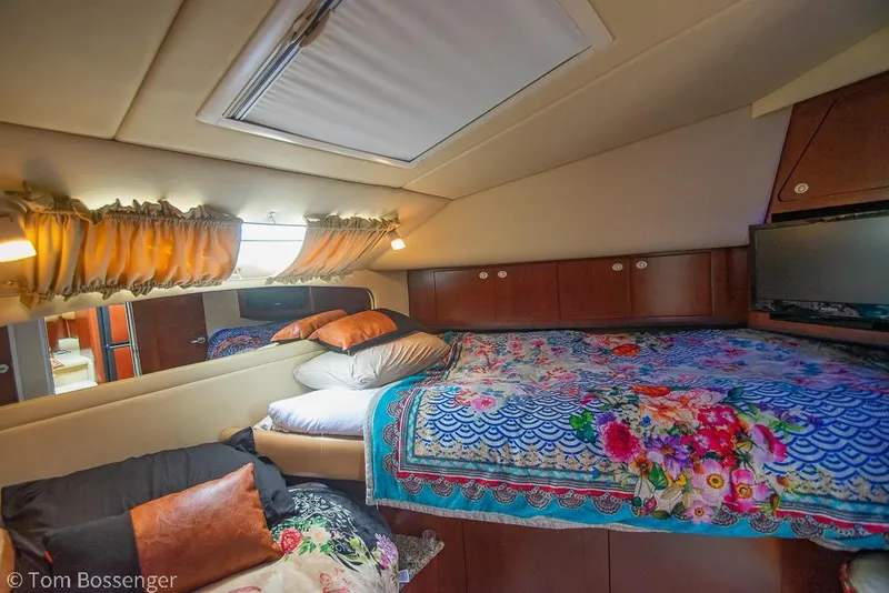 Slide: The Image of Cozy bedroom interior of 2005 Sea Ray 390 Motor Yacht with floral bedding and warm lighting. - 35