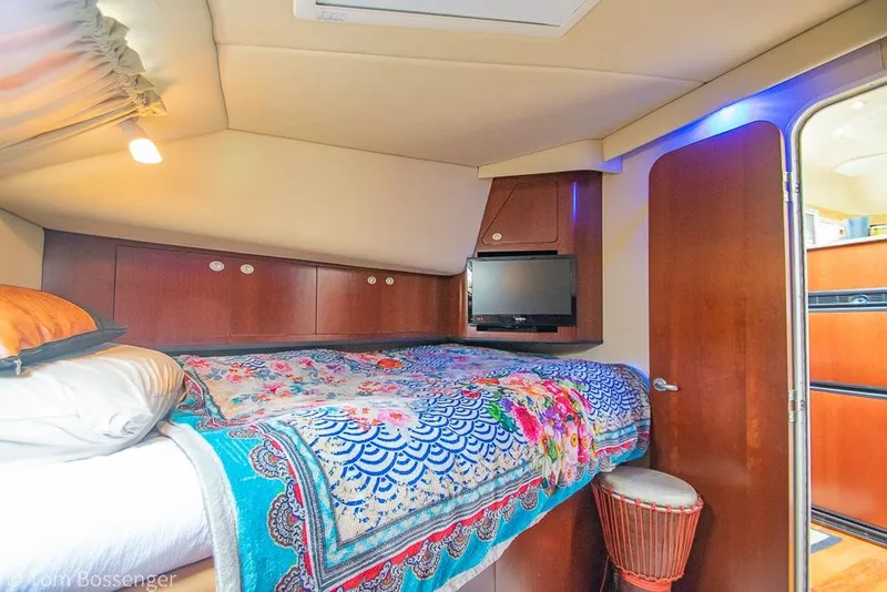 Slide: The Image of Luxurious 2005 Sea Ray 390 Motor Yacht bedroom with vibrant bedding and modern amenities. - 36