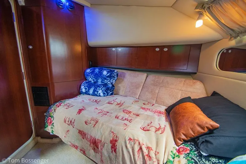 Slide: The Image of Luxurious 2005 Sea Ray 390 Motor Yacht cabin with cozy bedding and elegant wood paneling. - 37