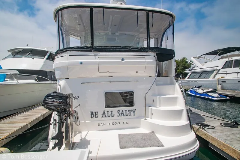 Slide: The Image of 2005 Sea Ray 390 Motor Yacht docked, rear view with "Be All Salty" nameplate. - 4