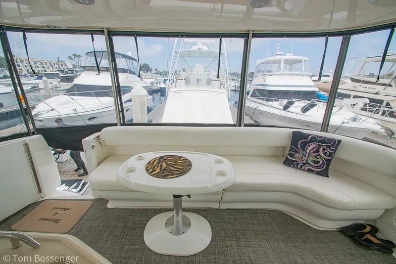 Slide: The Image of Luxurious 2005 Sea Ray 390 Motor Yacht interior with marina view, featuring white seating and table. - 44