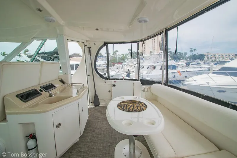 Slide: The Image of 2005 Sea Ray 390 Motor Yacht interior with seating and marina view. - 45