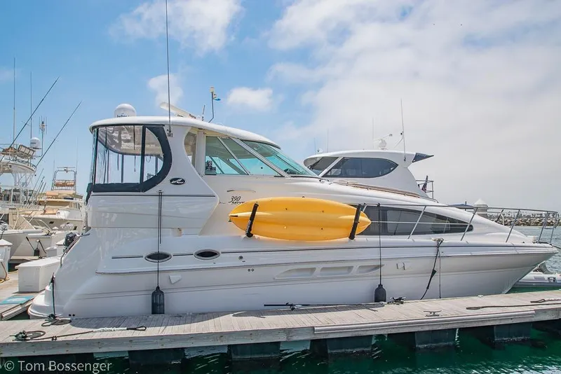 Slide: The Image of 2005 Sea Ray 390 Motor Yacht docked with a yellow kayak on the side. - 5