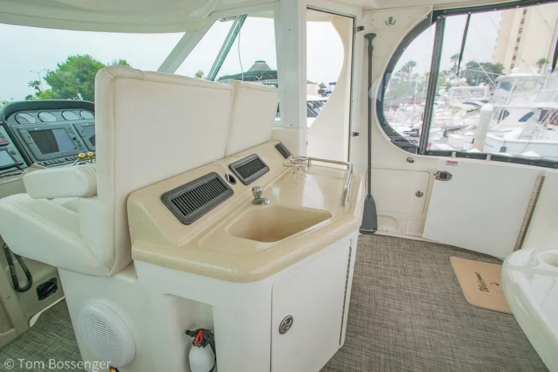 Slide: The Image of 2005 Sea Ray 390 Motor Yacht interior with helm, sink, and marina view. - 50