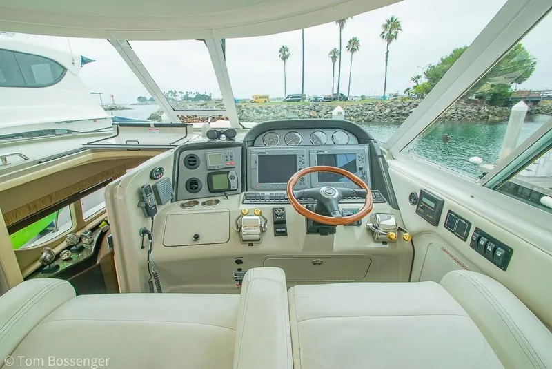 Slide: The Image of 2005 Sea Ray 390 Motor Yacht helm with modern controls and waterfront view. - 52