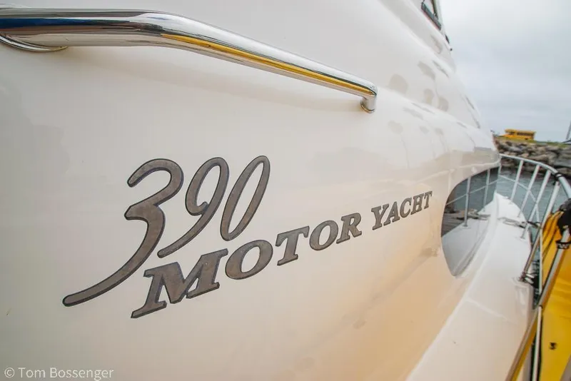 Slide: The Image of 2005 Sea Ray 390 Motor Yacht side view with logo and railing. - 57