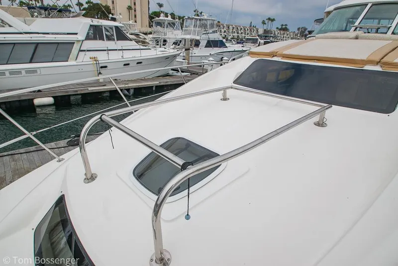 Slide: The Image of 2005 Sea Ray 390 Motor Yacht docked at marina, showcasing sleek design and spacious deck. - 59