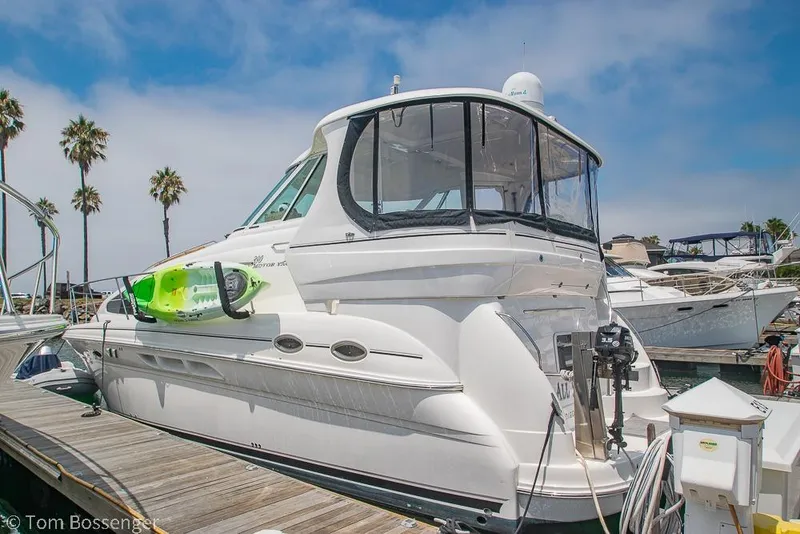 Slide: The Image of 2005 Sea Ray 390 Motor Yacht docked with kayak, palm trees in background. - 6