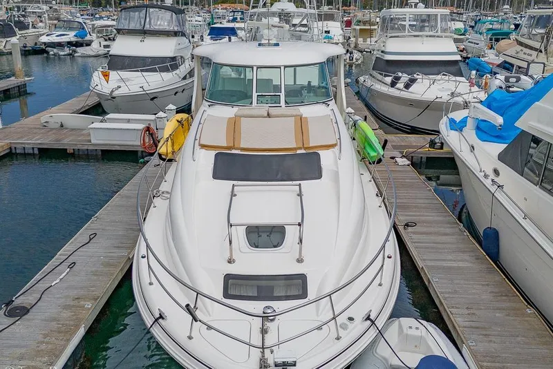 Slide: The Image of 2005 Sea Ray 390 Motor Yacht docked in a marina, surrounded by other boats. - 63
