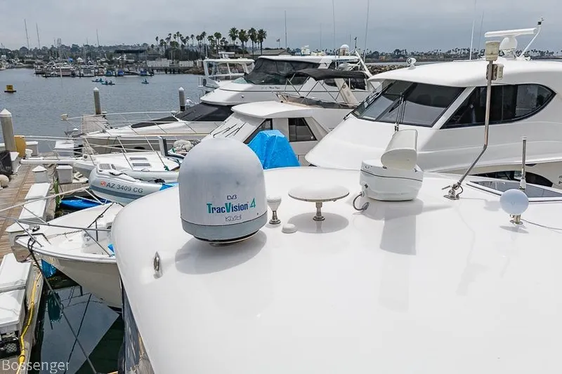 Slide: The Image of 2005 Sea Ray 390 Motor Yacht docked in marina, featuring TracVision satellite system. - 65