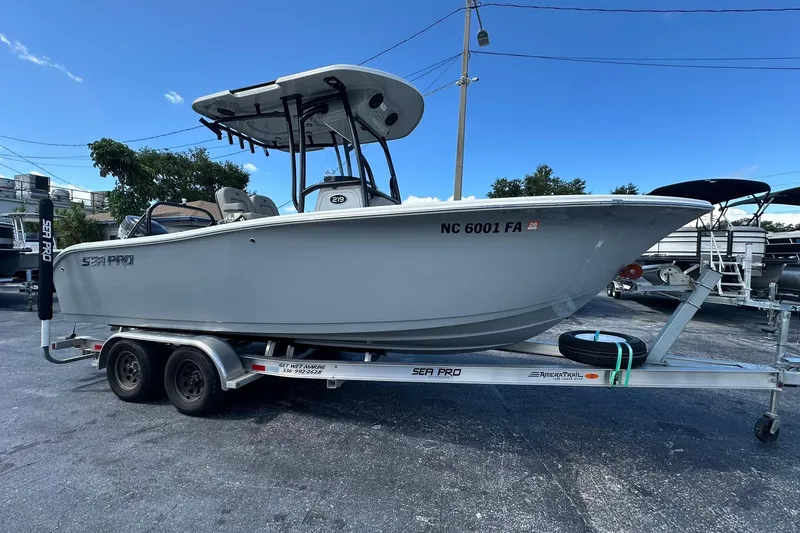 The Image of 2023 Sea Pro 219 Deep V CC boat on trailer, parked outdoors under clear sky. - 1