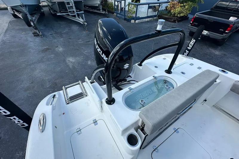 Slide: The Image of 2023 Sea Pro 219 Deep V CC boat with Suzuki outboard motor, docked in a marina. - 17