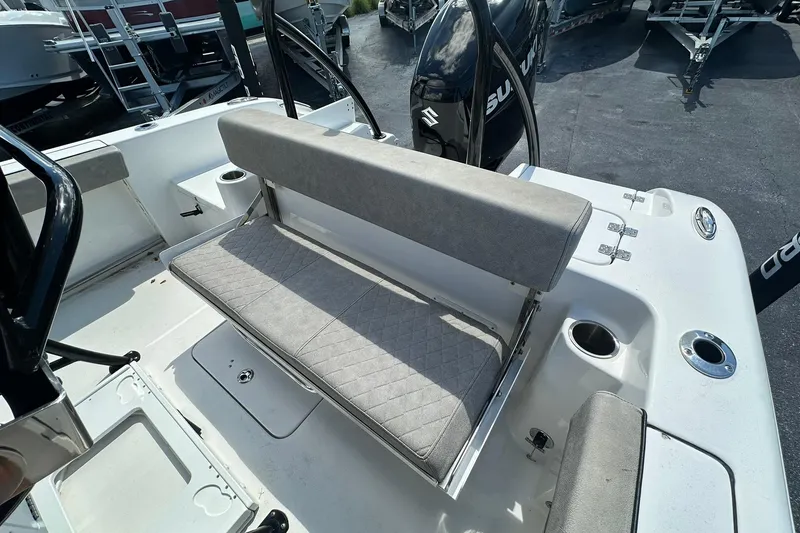 Slide: The Image of 2023 Sea Pro 219 Deep V CC boat interior with cushioned seating and cup holders. - 20
