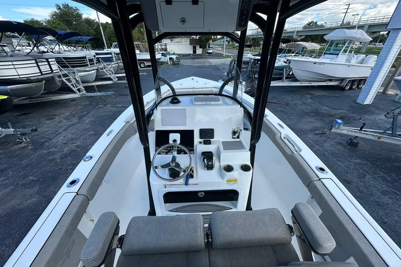 Slide: The Image of 2023 Sea Pro 219 Deep V CC boat interior with steering console and seating. - 23