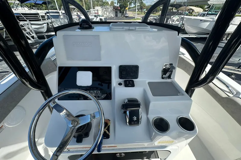 Slide: The Image of 2023 Sea Pro 219 Deep V CC boat console with steering wheel and controls. - 24