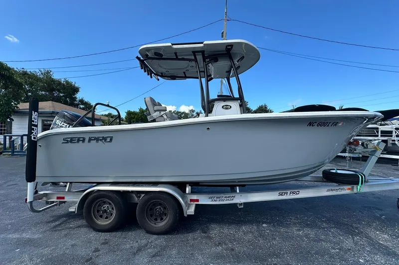 Slide: The Image of 2023 Sea Pro 219 Deep V CC boat on trailer, side view, clear sky background. - 3