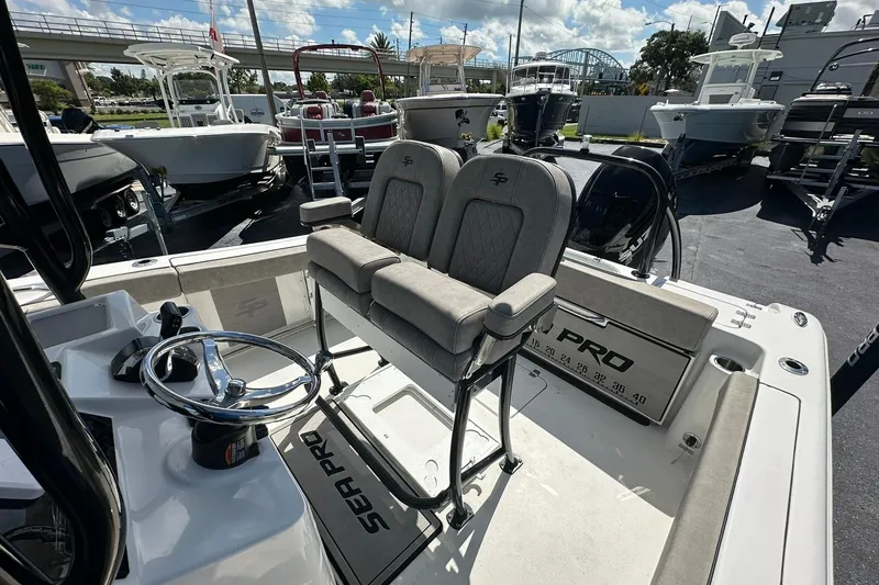 Slide: The Image of 2023 Sea Pro 219 Deep V CC boat interior with dual seats and steering wheel. - 30