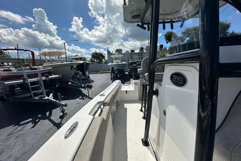 Slide: The Image of 2023 Sea Pro 219 Deep V CC boat on display under a bright, cloudy sky. - 32