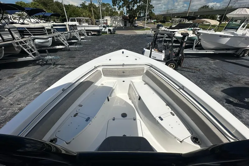 Slide: The Image of 2023 Sea Pro 219 Deep V CC boat interior at a dealership, showcasing spacious seating. - 35