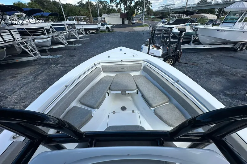 Slide: The Image of 2023 Sea Pro 219 Deep V CC boat with cushioned seating, parked in a marina. - 36
