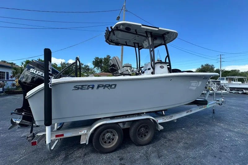 Slide: The Image of 2023 Sea Pro 219 Deep V CC boat on trailer, featuring Suzuki outboard motor. - 4