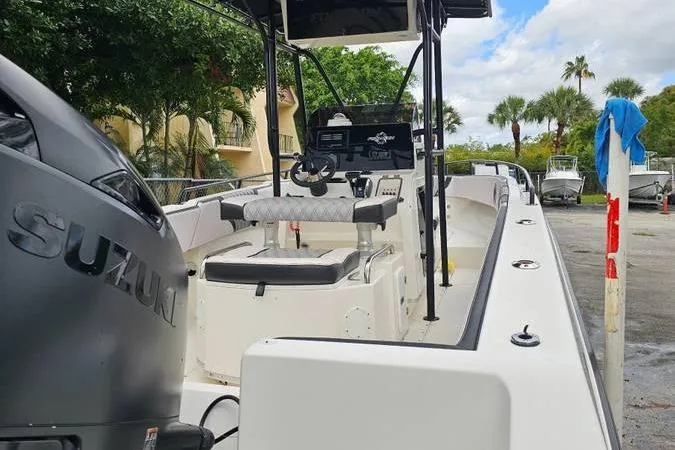 Slide: The Image of 1997 Fountain Sportfish 27 boat with Suzuki engine, docked outdoors. - 16