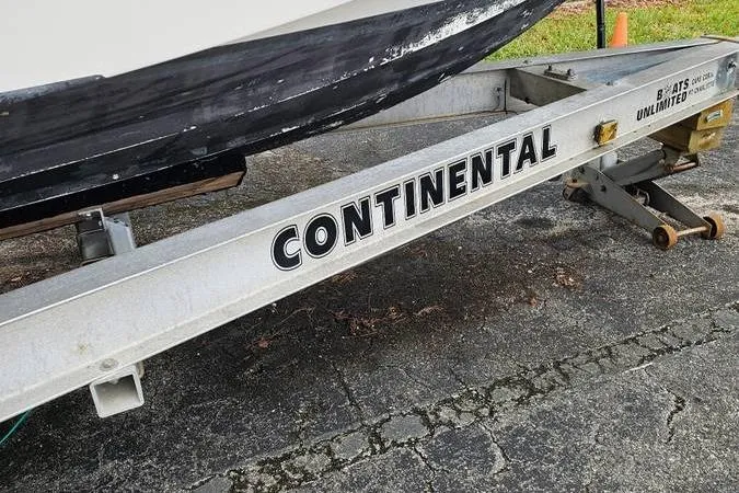 Slide: The Image of Continental boat trailer with 1997 Fountain Sportfish 27 on pavement. - 18