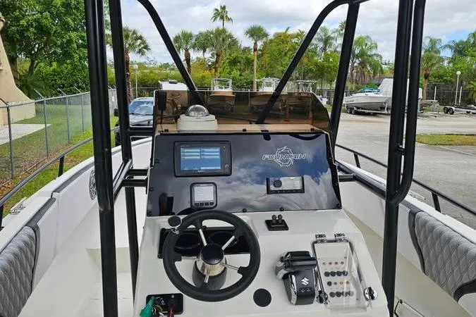 Slide: The Image of 1997 Fountain Sportfish 27 boat dashboard with steering wheel and navigation equipment. - 3