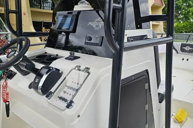 Slide: The Image of 1997 Fountain Sportfish 27 boat dashboard with steering wheel and control panel. - 6
