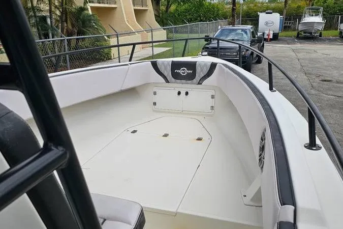Slide: The Image of 1997 Fountain Sportfish 27 boat, spacious deck, sleek design, parked outdoors. - 7