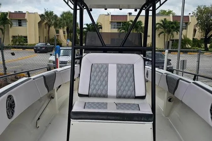 Slide: The Image of 1997 Fountain Sportfish 27 boat interior with seating and steering console. - 9