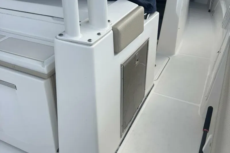 Slide: The Image of 2020 Pursuit S 328 Sport boat interior with storage compartment and seating. - 11