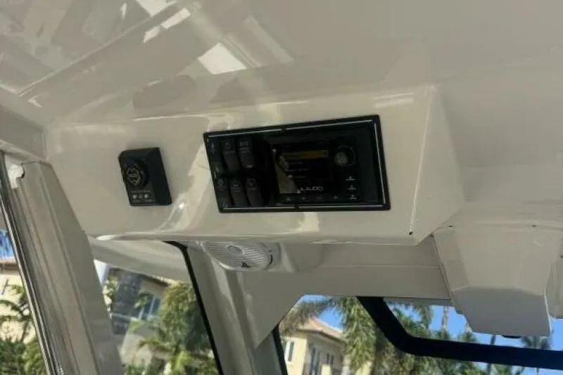 Slide: The Image of 2020 Pursuit S 328 Sport boat interior console with control panel and speaker. - 13