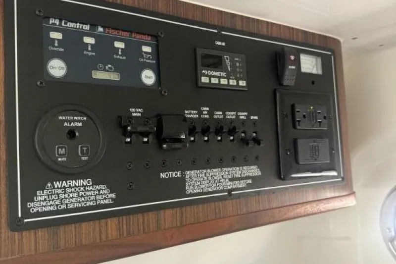 Slide: The Image of Control panel of a 2020 Pursuit S 328 Sport boat with various switches and warnings. - 14