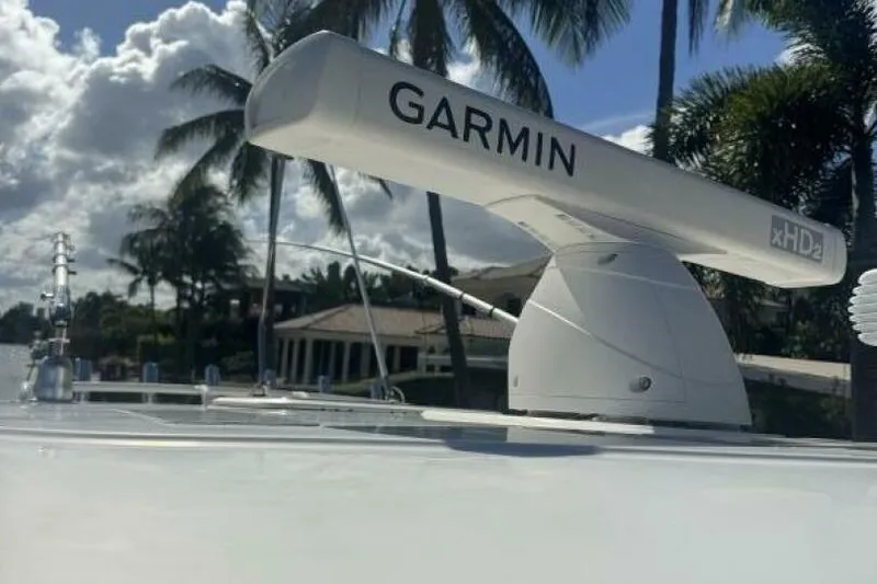 Slide: The Image of 2020 Pursuit S 328 Sport boat with Garmin radar, palm trees in background. - 16