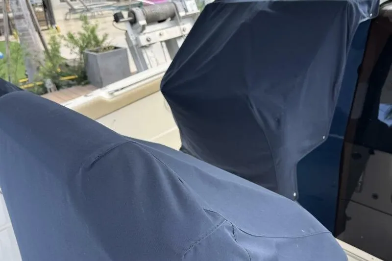 Slide: The Image of Covered seats on a 2020 Pursuit S 328 Sport boat, dockside view. - 18